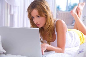 Woman online using laptop