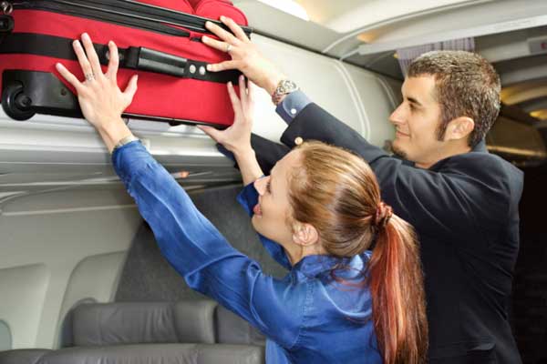 Man helping woman with her luggage