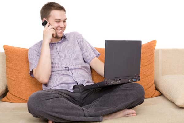 Man using laptop and phone