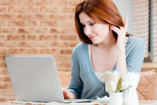Woman online using laptop computer